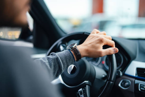 A close up view of an unrecognizable Caucasian male working as a taxi driver